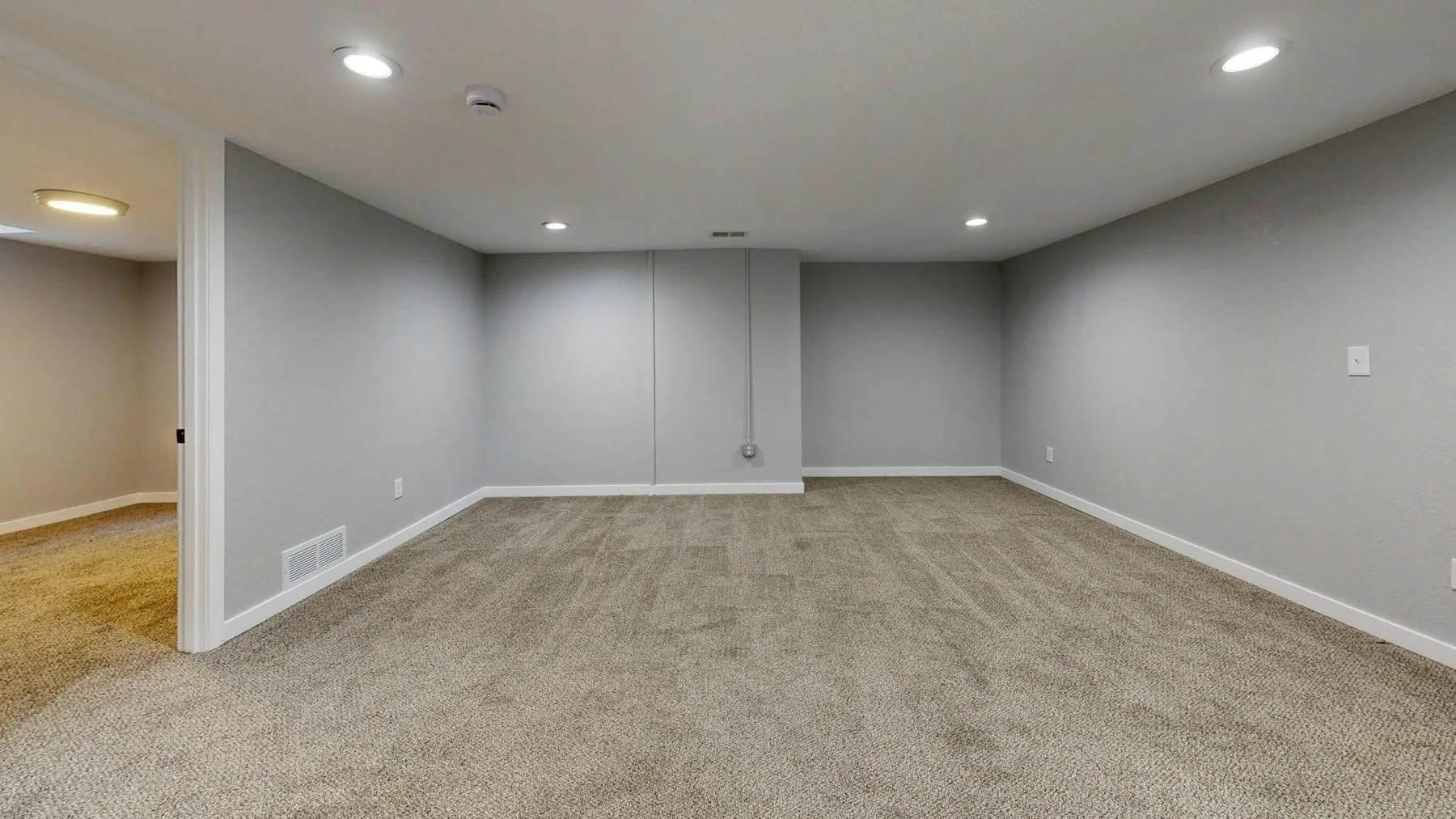 Luxury vinyl plank flooring in a finished basement family room — water-tolerant install over concrete
