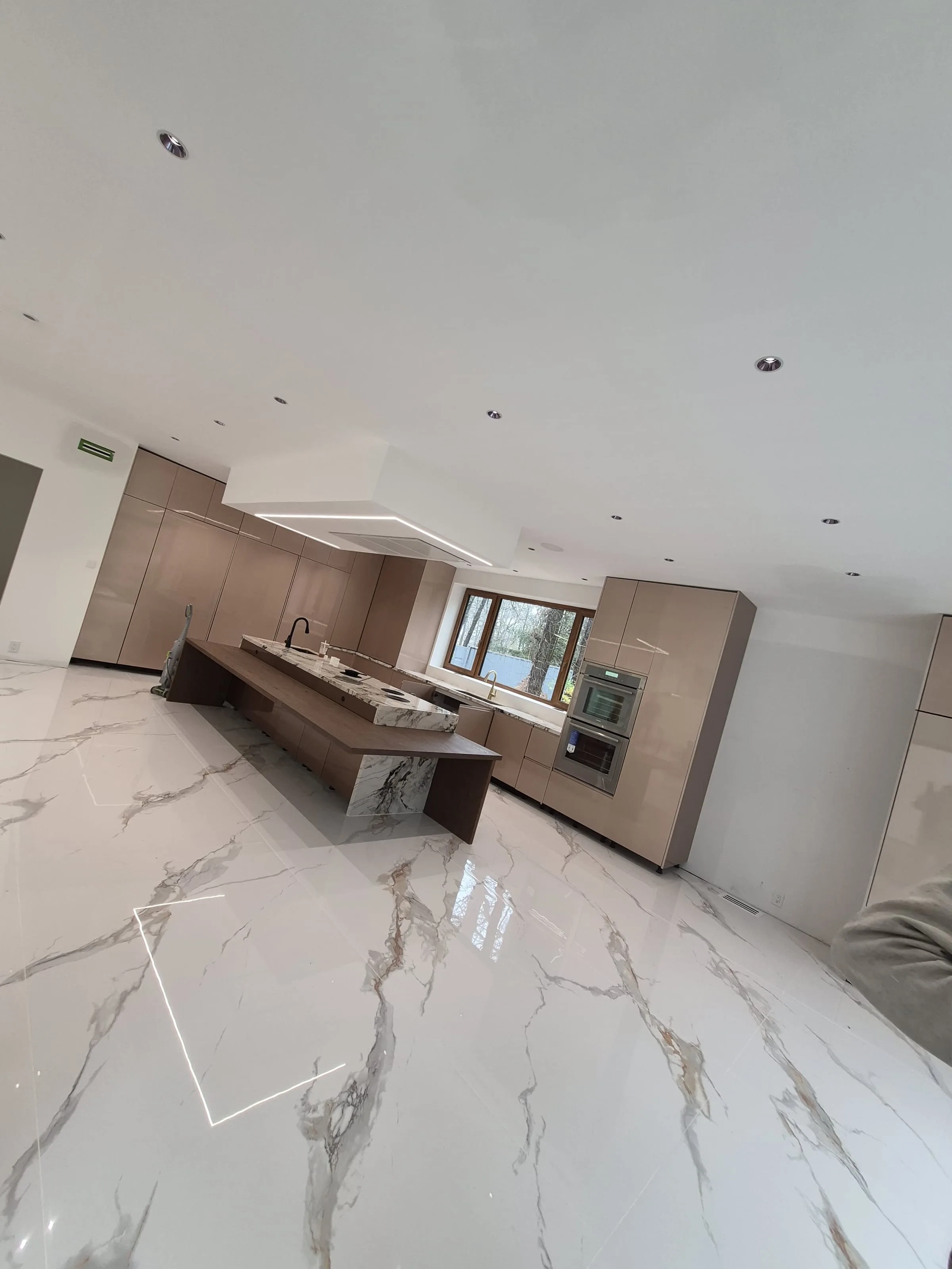 Pattern flooring reference — herringbone-adjacent layout in a high-finish-tier kitchen