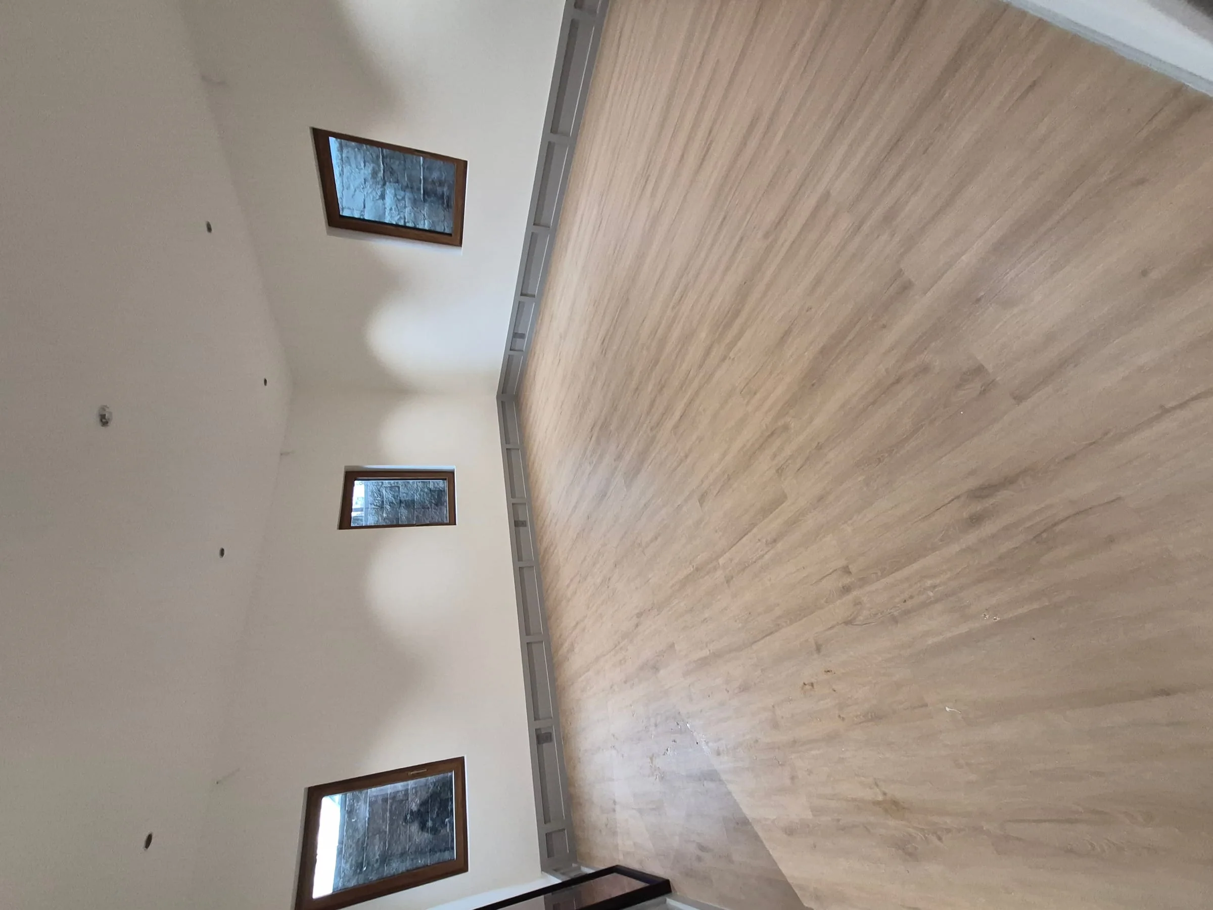 Wide-plank hardwood floor installation — engineered oak with site-applied finish, full dust containment
